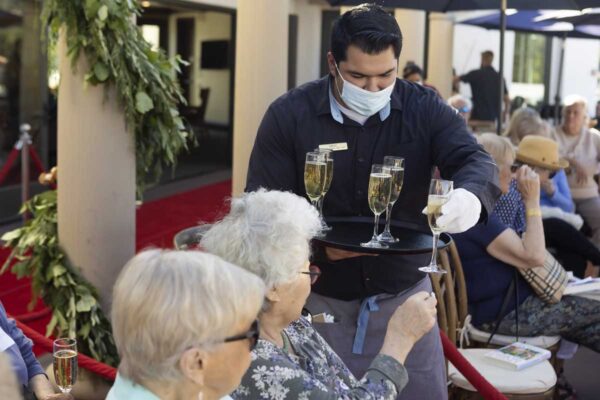 Residents and guests sip champagne at the Red Carpet Speaker Event.