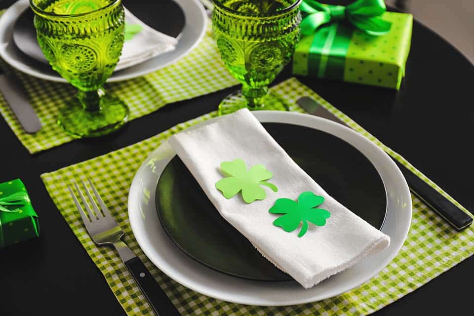 Green table settings with St. Patrick's day decorations.