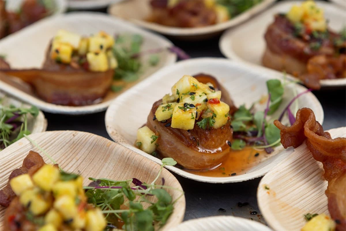 Beautiful bacon-wrapped meat appetizers on individual plates.