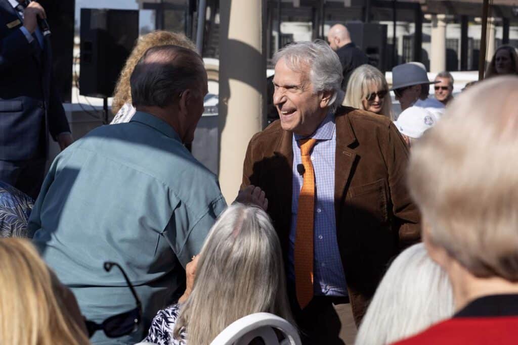 Henry Winkler posing for photos with residents and guests and the Red Carpet Speaker event.