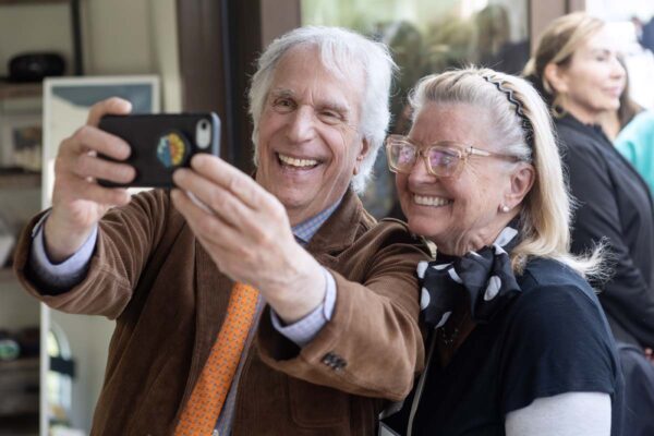 Henry Winkler posing for photos with residents and guests and the Red Carpet Speaker event.