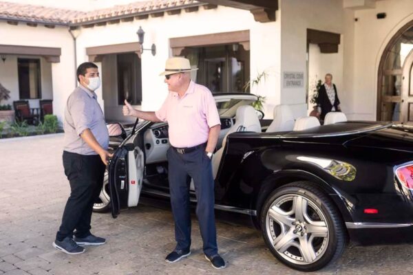 Crestavilla resident giving a valet a thumbs up as he drops off his Bentley convertible.